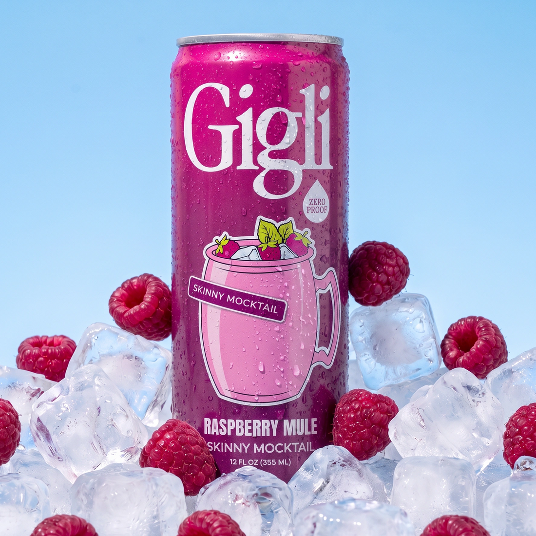 Close-up of a Raspberry Mule SKINNY Mocktail can surrounded by raspberries and ice
